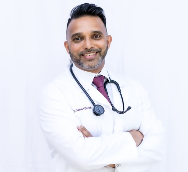 male veterinarian with a dog wearing stethoscope